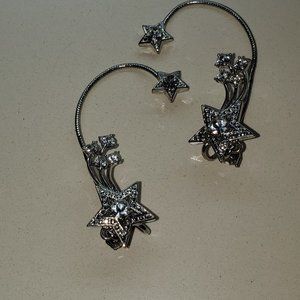 THIS IS A PAIR OF SILVER TONE EAR HUGGERS DONE IN CLEAR STONES.